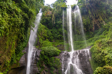 Sekumpul Waterfalls surrounded by tropical forest in Bali, Indonesia.