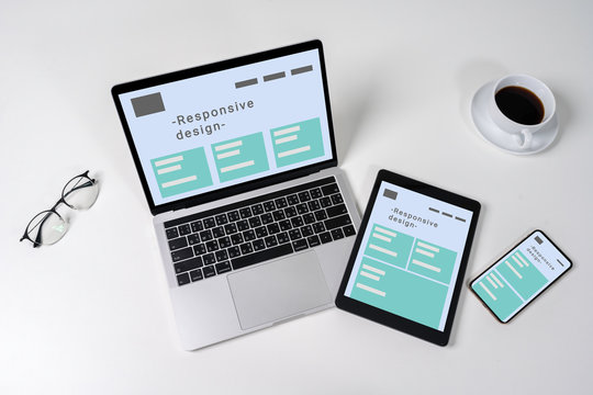 Responsive web design on laptop, tablet computer and mobile phone with clipping path from above.