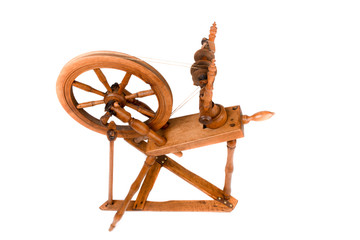 Closeup of old spinning wheel isolated on a white background. Very old wheel and spokes of a hand crafted spinning wheel made from natural wood. Historical working tool. Isolated, white background