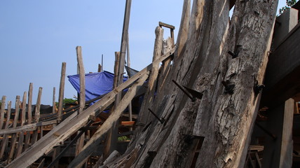 Fototapeta na wymiar Timber shipbuilder working while working at a shipyard, Batang Indonesia,