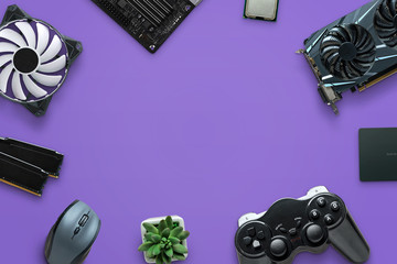 Concept of assembling a gaming computer on purple surface. Free space in the middle for text, logo...