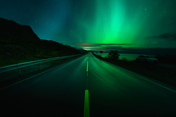 Road by nountain with aurora in Norway