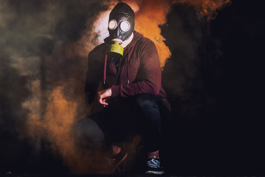 A man in a mask surrounded by smoke in a old building. Horror / Halloween Concept