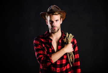 farmer culture. man checkered shirt on ranch. cowboy with lasso rope. Western. Vintage style man. Wild West retro cowboy. western cowboy portrait. wild west rodeo. man in hat black background