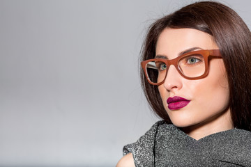 Portrait of beauty model with natural make up wearing eyeglasses and scarf