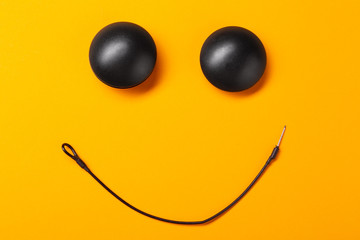 on a yellow background smiley from anti-theft magnetic clips, business security concept