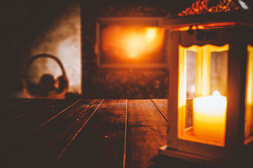Table top with blurred fireplace and cosy home interior background.