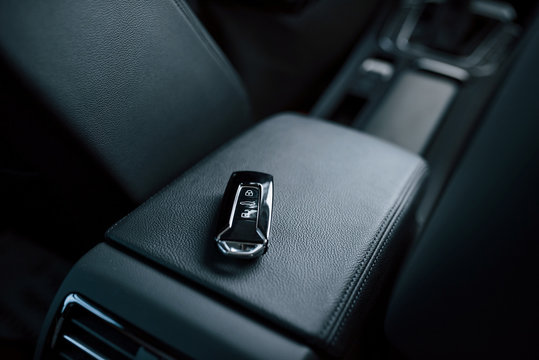 Close up photo of keys lying donw inside brand new modern car