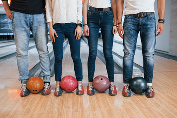 Modern street wear. Cropped view of people at the bowling club ready to have some fun