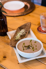 truffle mushroom soup with brown bread topped with alfalfa 