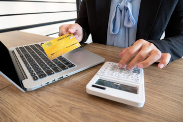 Business women use credit cards and laptops for online shopping and making payments the internet