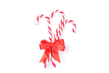 Sweet candy canes with bow isolated on white background