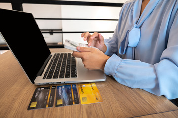 Business women use credit cards and laptops for online shopping and making payments the internet
