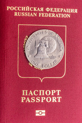Russian passport and coin in one dollar on it. The passport of the traitor.