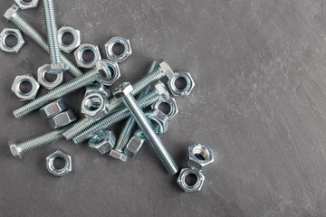 Nuts and bolts steel metal on slate base