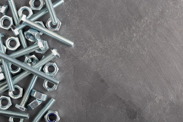 Nuts and bolts steel metal on slate base