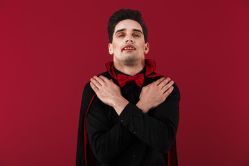 Image of vampire man with fangs in black halloween sleeping as dead