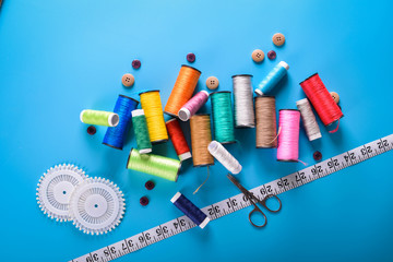 Sewing kit: scissors, measuring tape, thimbles, threads and buttons. Composition with threads and...