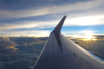 Fototapeta na wymiar Wing air plane and the sun
