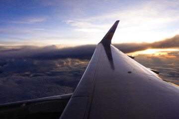 Fototapeta na wymiar Silhouette at sunset on air plane
