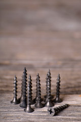  screws on a wooden background