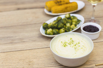 Potato puree in bowl with brussels sprouts