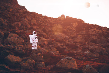Astronaut exploring a new planet. Searching for a new home for humanity. Concept about science and...