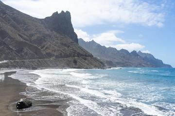 Fototapeta na wymiar Scenery beach with volcano sand and majestic cliff in Anaga. Playa de Las Bodegas, Tenerife, Canary Islands.