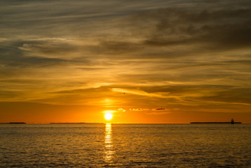 Colorful orange beautiful sunset on sea summer background. Hot and romantic sunset over the ocean. Calm landscape.