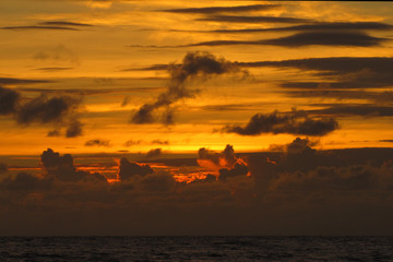 beautiful red sunset over the ocean. Bright sunset with large yellow sun under the sea surface. sundown seascape