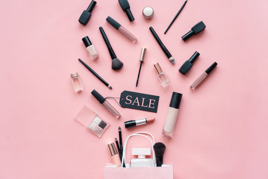 Makeup Cosmetic Perfume Women Products Accessories Pouring From Shopping Bag On Pink Flat Lay Background, Beauty Products Cheap Discount Retail Offer Online Purchase, Top View Above Copy Space