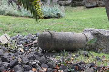 A fragment of an old column lies on the grass