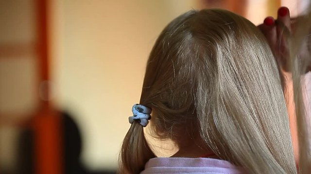 children girl hairstyle mother hand hd footage 