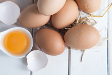 Eggs chicken on white wood background