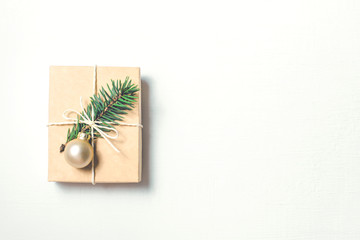 Christmas gift with fir branch on white background.