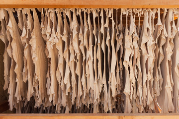 Leather hanging out for drying. The tanneries are located in the medina of Fez, Morocco. It's a...