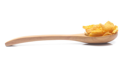 Cornflakes on spoon wood isolated on white background