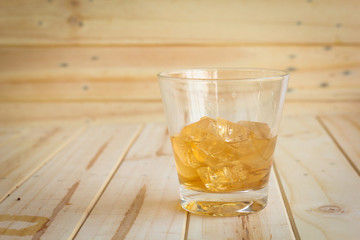 ice tea with slice of lemon in glass on the wooden background