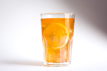 Fototapeta na wymiar Glasses of ice tea with lemon slices and mint on white background