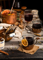 homemade mulled red wine with cinnamon, anise, cardamon and orange in glass jars
