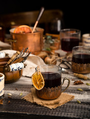 homemade mulled red wine with cinnamon, anise, cardamon and orange in glass jars
