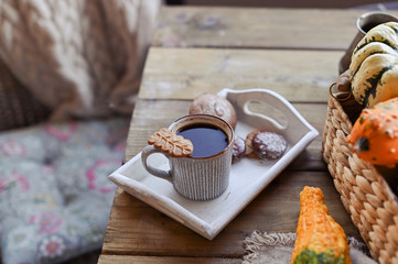 Autumn, pumpkins, hot steaming cup of coffee on a wooden table background. Seasonal, morning coffee with biscuit cinnamon cookies, sunday relaxing and still life concept.