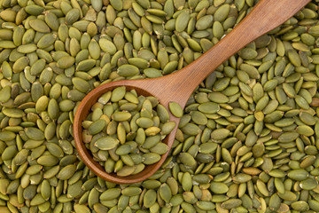 Pumpkin seeds and wooden spoon 