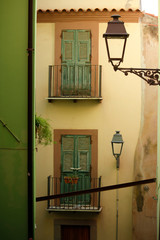 Italian narrow street with yellow and green houses
