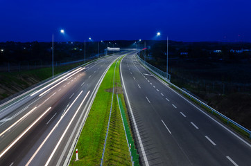 ON THE ROAD AT NIGHT - Car traffic on a modern expressway