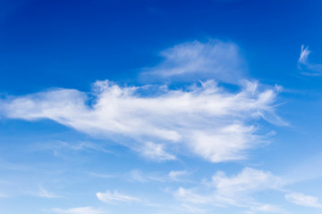 Naklejka na ściany i meble white fluffy clouds on a background of blue sky on a clear summer day