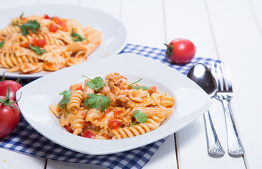 Spaghetti pasta with and tomato sauce on wood background