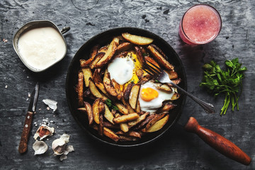 Fried potatoes and eggs in a pan close-up. horizontal