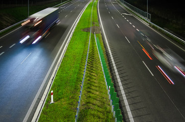 Fototapeta na wymiar ON THE ROAD AT NIGHT - Vehicles on a modern expressway