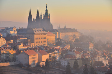 Prague Castle and St. Vitus Cathedral in Prague, Czech Republic. Early morning. Orange sunrise....